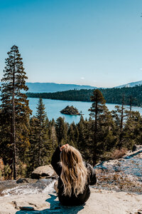 woman sitting at lake tahoe lookout point