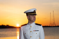 USNA Midshipman Senior portrait at sunrise on the sea wall in Annapolis, Maryland.