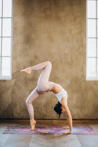 An individual practicing yoga in a bridge pose, exuding strength and flexibility.