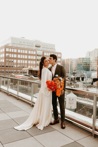 bride and groom posing on a bridge