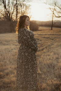 Pregnant mom hold her belly for sunset maternity portrait at Trexler Nature Preserve in Schnecksville PA