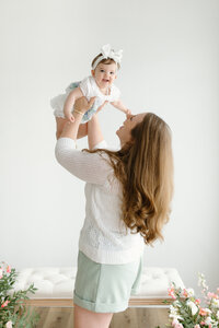 Family of five sitting on couch during photo session with Indianapolis newborn and family photographer Capturing Simplicity Photography