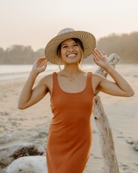 woman holding hat