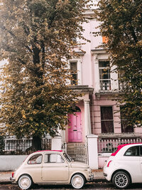 Pink Home with Cars and Trees in Front