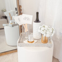 The Luxe Experience showing rating signs for the guests, bottle of champagne and flowers at our semi private stage/ seating area.