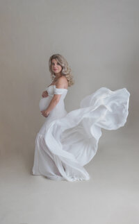 Maternity beautiful mama in flowing white gown
