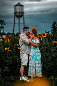 couple kisses in a sunflower field in upstate ny 