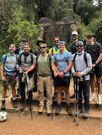 a group of young men on a hike to raise money for pediatric cancer