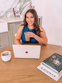 Natalie Sitting at a desk with a coffee and a computer