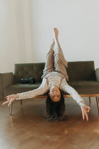 woman upside down on couch laughing