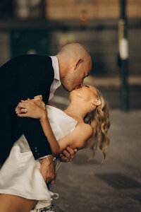 Groom kissing the bride while dipping her during sunset, captured by a wedding photographer Sunshine Coast.