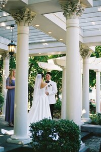 bride and groom standing at the altar at wedding, bride in white dress, groom in white tuxedo, destination wedding photography