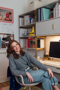 Interior Designer Erin Lima sits in her home office in front of a computer. 