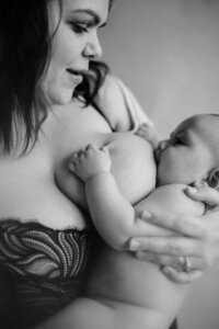 black and white image mother breast feeding baby