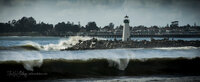 Breaking waves at Santa Cruz Harbor’s Walton Lighthouse, viewed from Twin Lakes Beach.