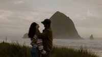 young couple looking at each at Cannon Beach Oregon