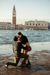 A guy proposes to his girlfriend at sunset on San Giorgio Island in Venice