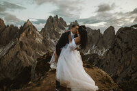 bride and groom kiss in front of Cadini di Misurina Dolomites