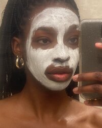 Mirror selfie photo of Tomachi with a face mask on.