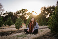 San Antonio Photographer Irene Castillo sitting a field of trees