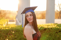 Senior pictures of girl at sunset with graduation cap