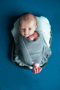 baby boy wrapped newborn photography