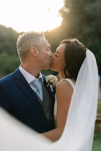 Tow brides in white wedding dressing holding bouquets.