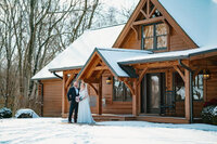 Bride and groom standing in the snow, sharing an intimate moment at sunset