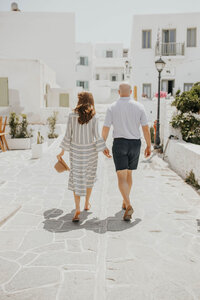 A couple walking together on the streets of Greece 