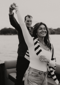 A couple twirling around and smiling for a photo