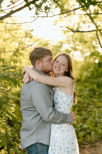 couple walks through field during engagement photoshoot