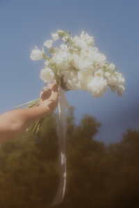 bouquet of flowers being held high in the air