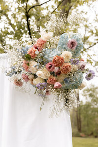 Arrangement of flowers hanging on a white cloth