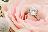 Beautiful detail photo of the brides ring in a pink rose on her bouquet during her Wedding in Utah by Andria Joleen Photography