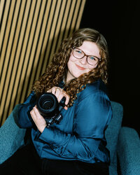 Flash image of Allison Bolin Texas wedding photographer holding her camera