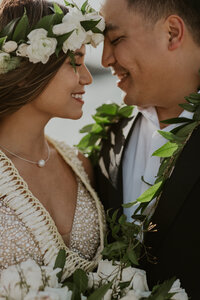 bride and groom hugging in ocean