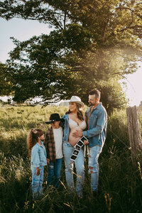 Family of 4 wearing all blue jean outfits in the park during their session in Kitchener, Ontario.