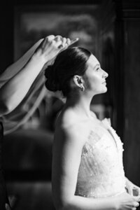 candid laughing bride with veil flowing in the wind at wilburn street studio nashville wedding