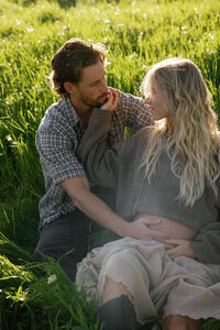 the couple is enjoying their mountainous view during their engagement photos in colorado