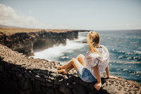 girl sitting by the ocean