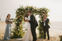 couple kissing during cape may beach ceremony