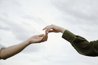 a couple holding hands with sky in the background taken by Elopement photographer in leadville