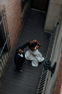 A groom spins his bride in an alleyway at 1801 Washington Place in Columbia, SC.