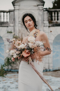 Modern whimsical bridal photo with her colorful wedding bouquet.