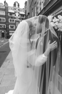 BRIDE AND GROOM EXCHANGE VOWS DURING THEIR WEDDING CEREMONY AT THE FITZROVIA CHAPEL IN LONDON