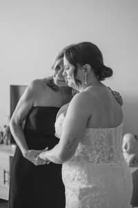 Two people lean in for a kiss on their wedding day