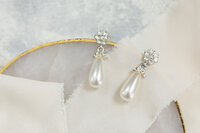 Pearl earrings on a gold edged slice of quarts