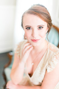 getting ready bride portrait with natural makeup on a vintage victorian couch