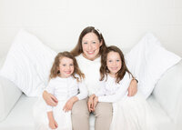 Image of a family posing for chirstmas photos in 2021 by Lauren Vanier Photography, Hobart's premier family photographer