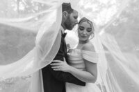 Tallahassee, North Florida couple posing with the bride's veil. 